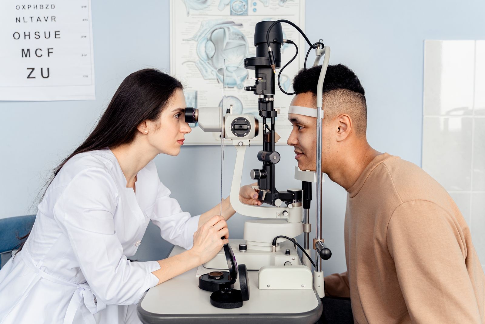 A clinician examining a patient’s eyes with a slit lamp